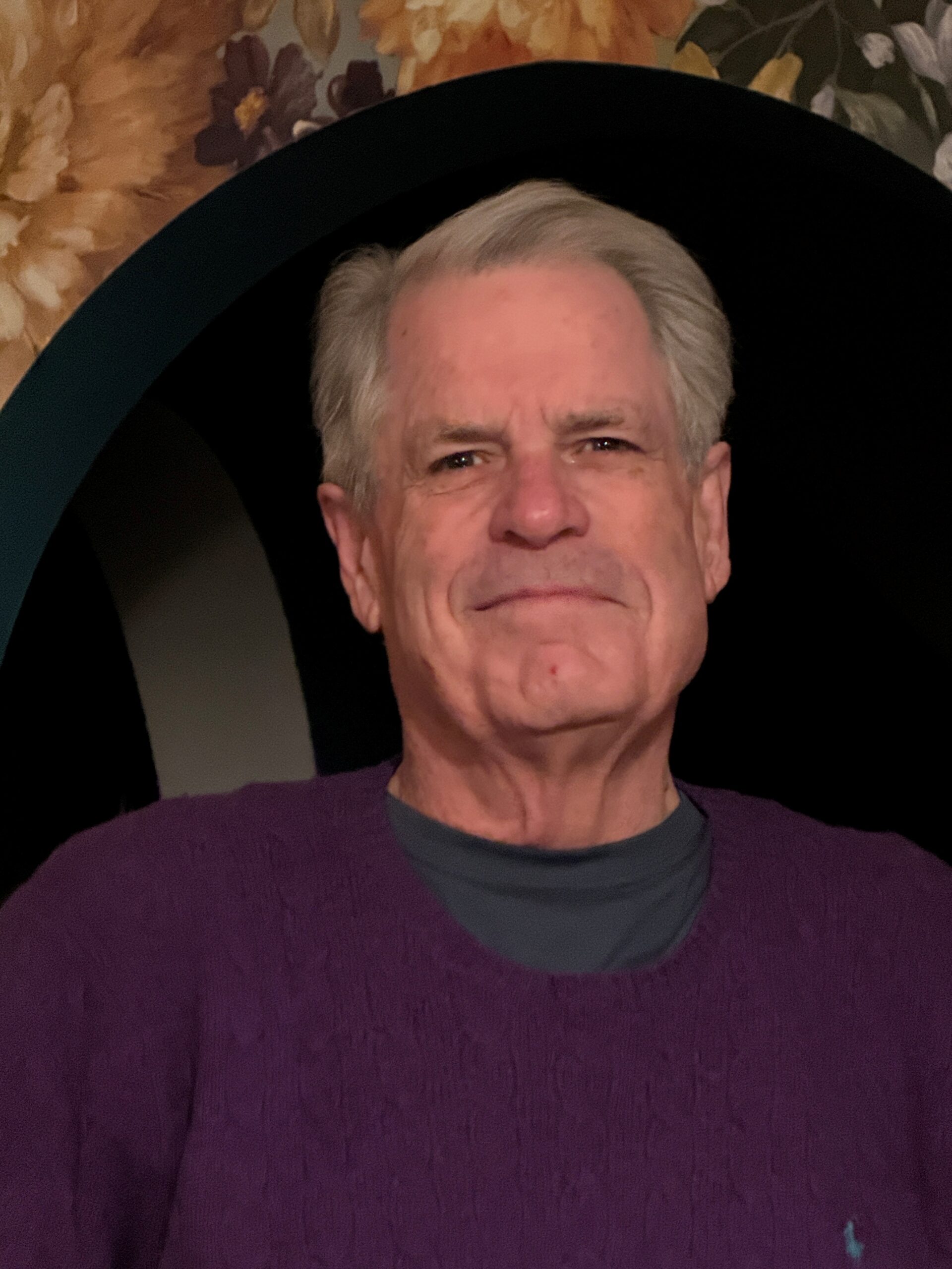 Headshot of man in dark purple shirt
